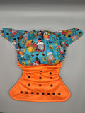 SassyCloth one size pocket cloth diaper with gnomes and turkeys cotton print.