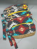 Clematis wristlet clutch with geometric and rainbow print and removable strap.