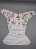 Cloth diaper SassyCloth one size pocket diaper with floral unicorns white cotton print.