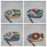 Clematis wristlet clutch with geometric and rainbow print and removable strap.