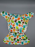 SassyCloth one size pocket cloth diaper with hatching dino cotton print.